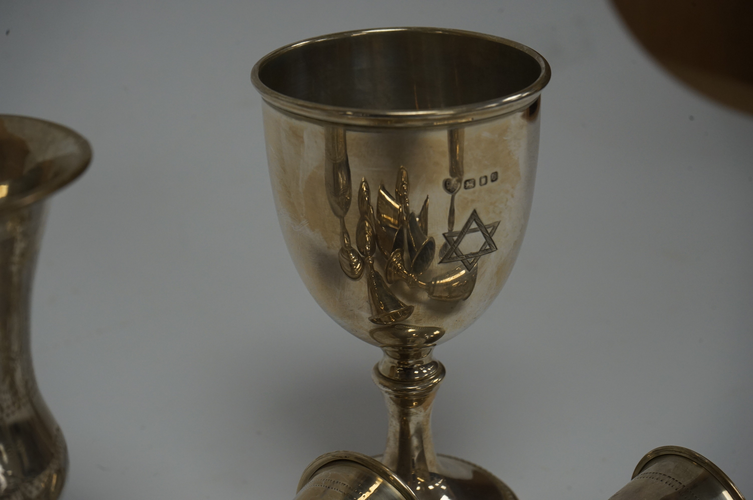 A set of six George V silver kiddush cups, maker MS?, London, 1924, 95mm, together with one other larger earlier silver kiddush cup and a 1960's silver goblet. Condition - poor to fair